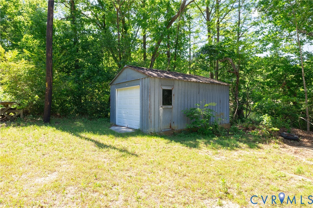 933 Pleasant Point Road Surry, VA 23883 - Photo 20 of 45 a backyard of a house with plants and large trees