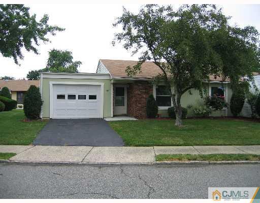 a front view of a house with a yard and a garage