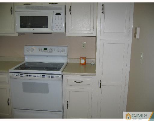 32 A Haddon Road Monroe Township, NJ 08831 - Photo 3 of 8 a view of a kitchen with stove and microwave