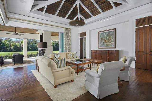 a living room with furniture and a floor to ceiling window