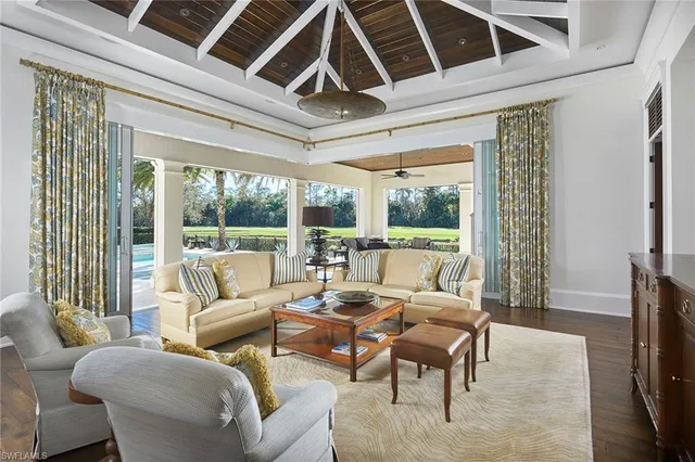 a living room with furniture a fireplace and a flat tv screen