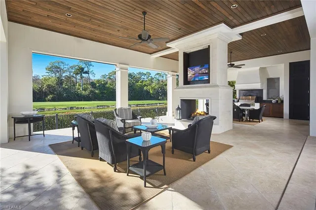 a dining room with furniture a fireplace and a flat screen tv