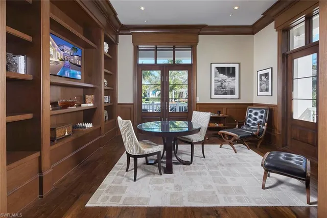 a bedroom with furniture and a large window