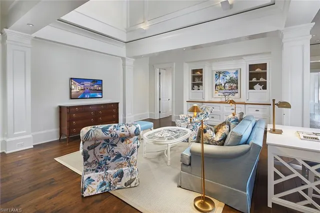 a living room with fireplace furniture and a wooden floor
