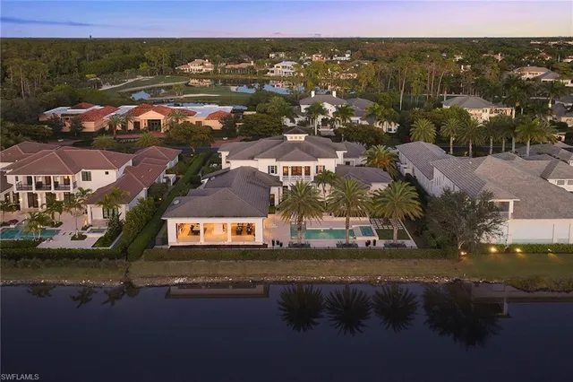 an aerial view of a house with a lake view
