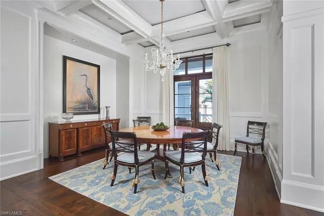 a kitchen with a stove chandelier and wooden floor
