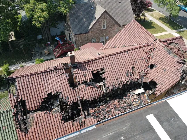a view of a brick house with wooden fence
