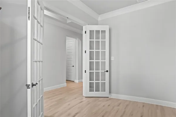 an empty room with wooden floor and closet