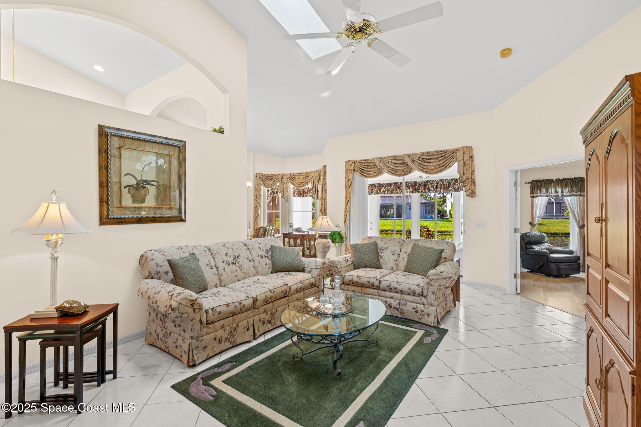 7702 Candlewick Drive Melbourne, FL 32940 - Photo 11 of 37 a living room with furniture and a large window