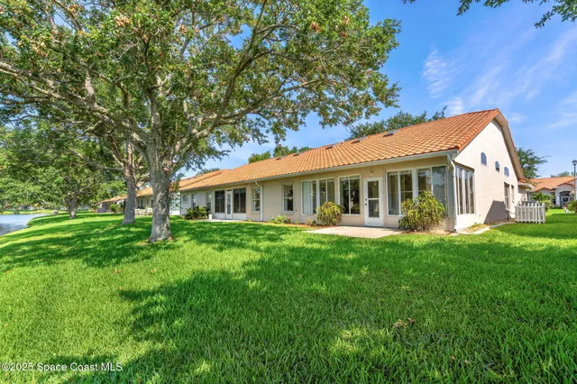 a front view of a house with yard patio and green space