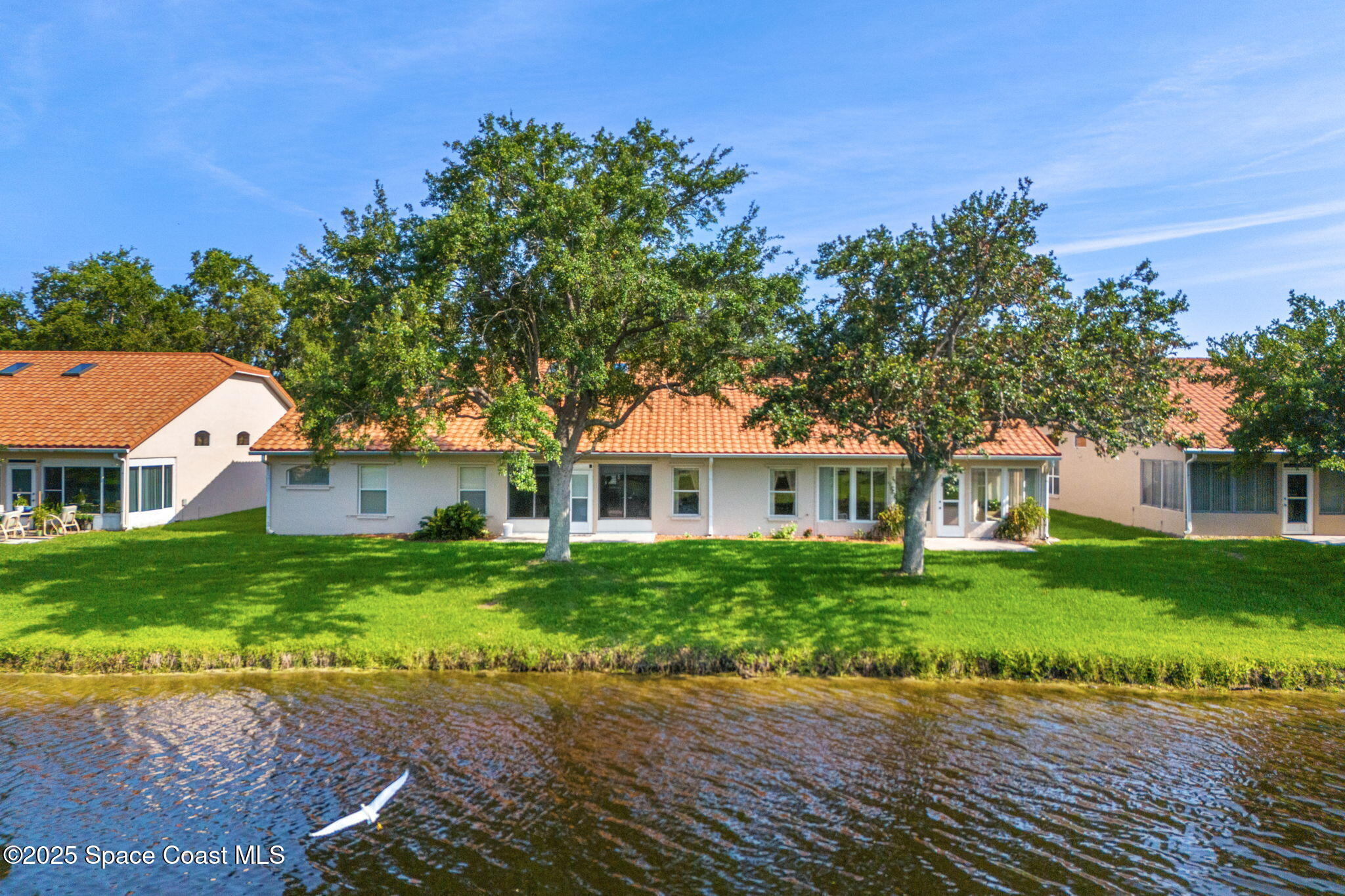 7702 Candlewick Drive Melbourne, FL 32940 - Photo 30 of 37 front view of a house with a yard
