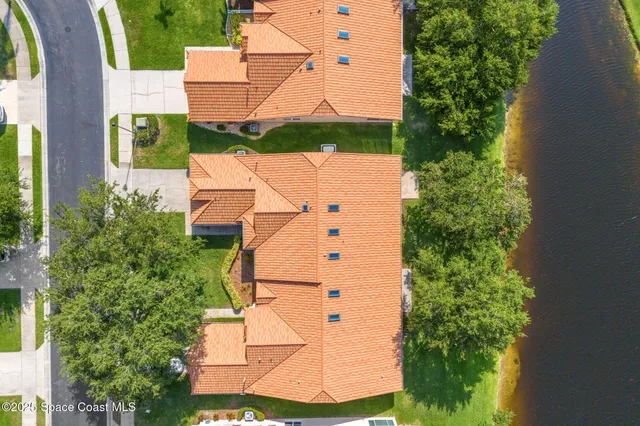 an aerial view of a house with a yard and garden