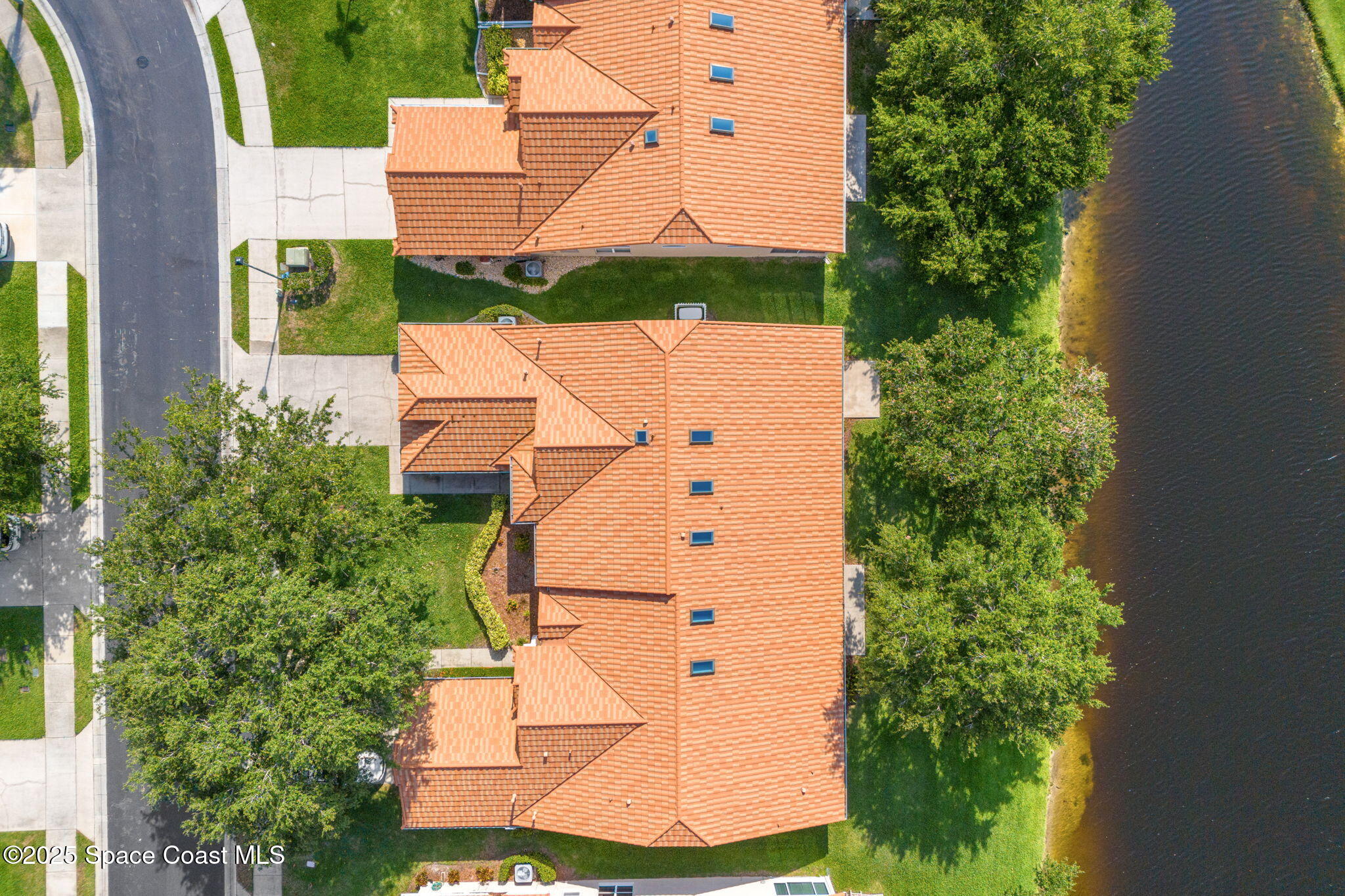 7702 Candlewick Drive Melbourne, FL 32940 - Photo 32 of 37 an aerial view of a house with a yard and garden