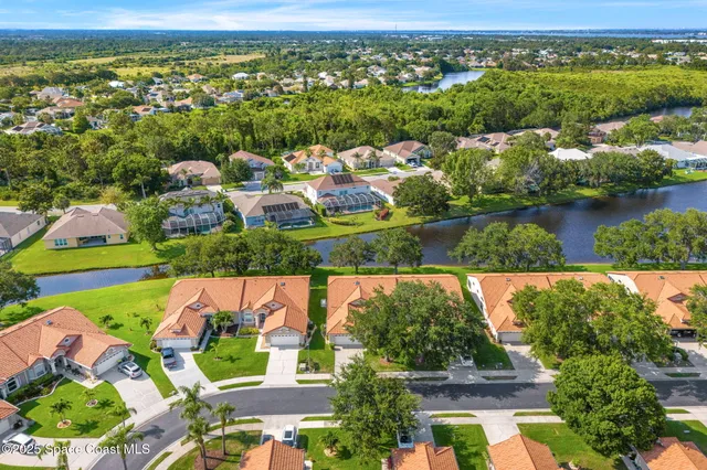 an aerial view of residential houses with outdoor space and river