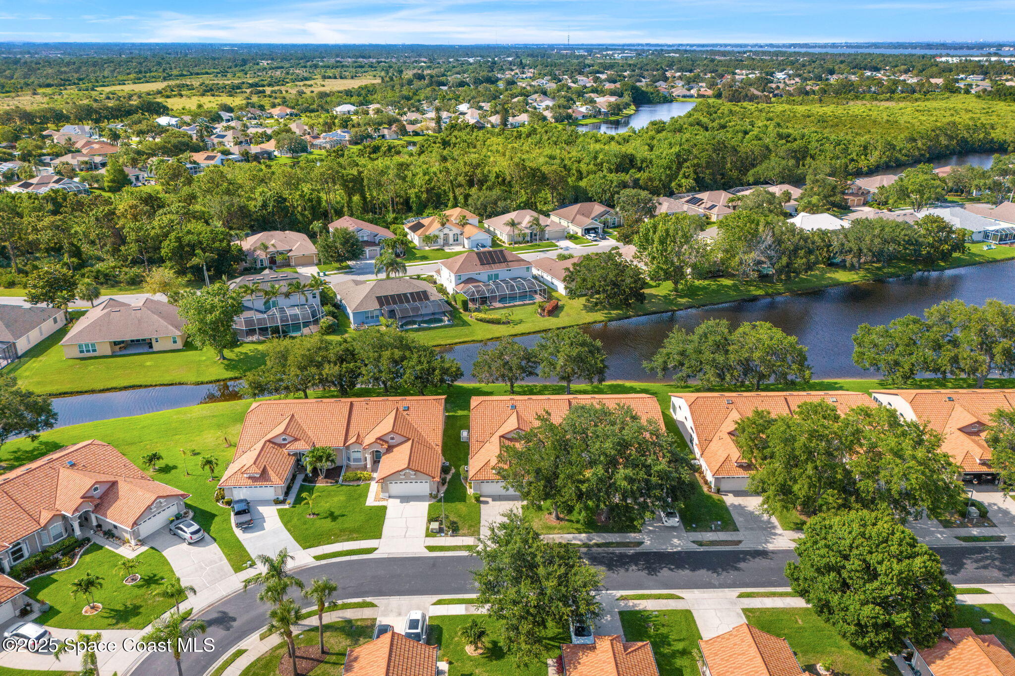 7702 Candlewick Drive Melbourne, FL 32940 - Photo 33 of 37 an aerial view of residential houses with outdoor space and river
