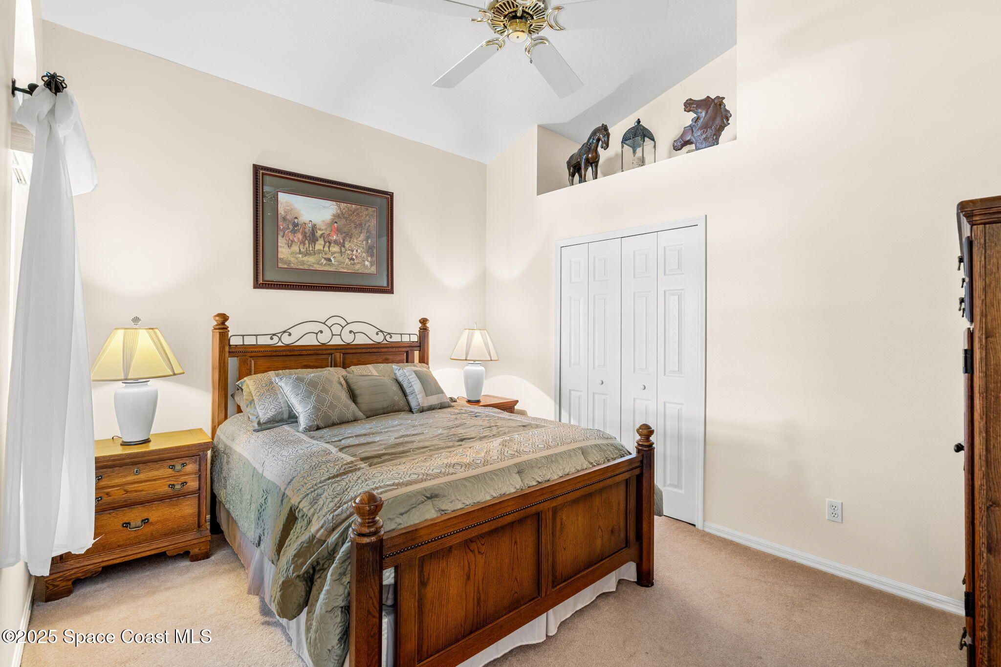 7702 Candlewick Drive Melbourne, FL 32940 - Photo 6 of 37 a bedroom with a bed and a chandelier