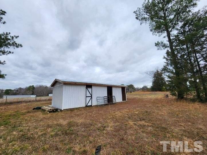 5209 Pulley Town Road Zebulon, NC 27597 - Photo 7 of 9 a big house with a big yard and large tree