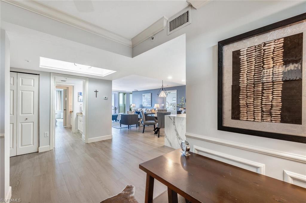 6849 Grenadier Boulevard, Unit 503 Naples, FL 34108 - Photo 14 of 50 a room with lots of table chair and wooden floor