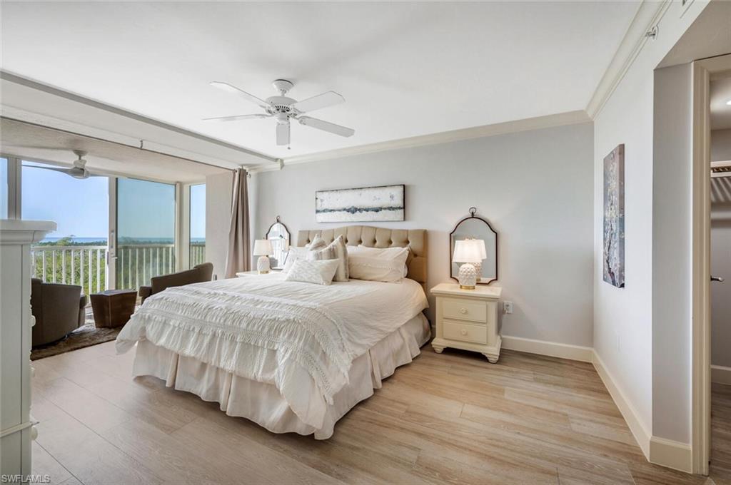 6849 Grenadier Boulevard, Unit 503 Naples, FL 34108 - Photo 15 of 50 a bedroom with a bed and large window