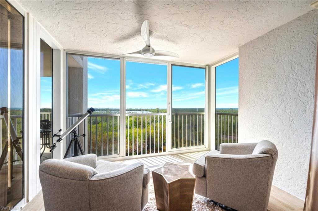 6849 Grenadier Boulevard, Unit 503 Naples, FL 34108 - Photo 17 of 50 a living room with furniture and a large window