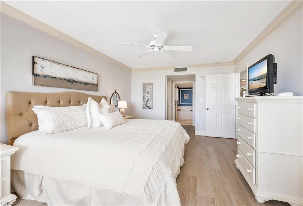 6849 Grenadier Boulevard, Unit 503 Naples, FL 34108 - Photo 19 of 50 a spacious bedroom with a bed and a flat screen tv