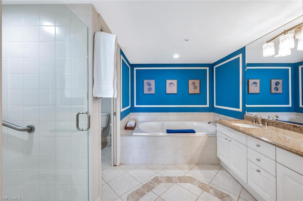 6849 Grenadier Boulevard, Unit 503 Naples, FL 34108 - Photo 20 of 50 a bathroom with a bathtub sink and mirror