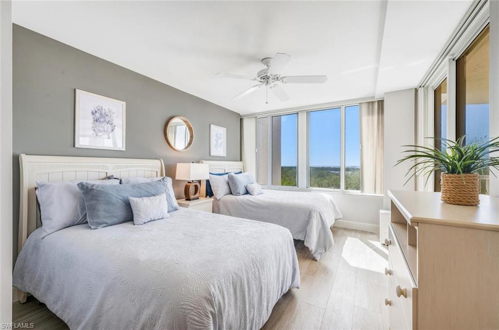 6849 Grenadier Boulevard, Unit 503 Naples, FL 34108 - Photo 23 of 50 a bedroom with bed and a large window