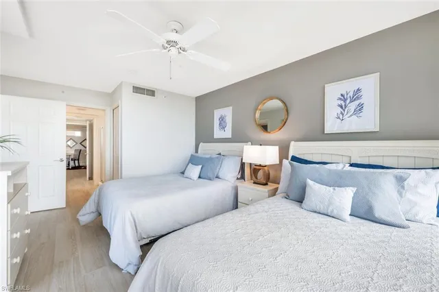 a bedroom with bed and a chandelier