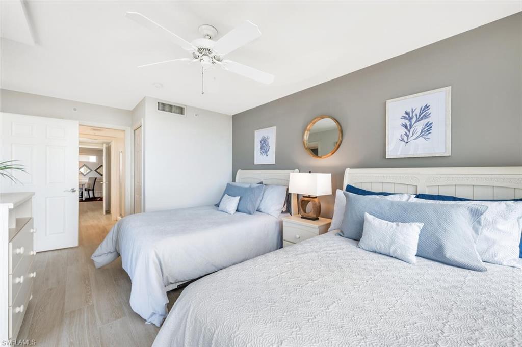 6849 Grenadier Boulevard, Unit 503 Naples, FL 34108 - Photo 25 of 50 a bedroom with bed and a chandelier