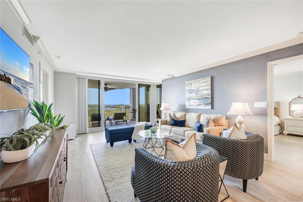 6849 Grenadier Boulevard, Unit 503 Naples, FL 34108 - Photo 7 of 50 a living room with furniture and a large window