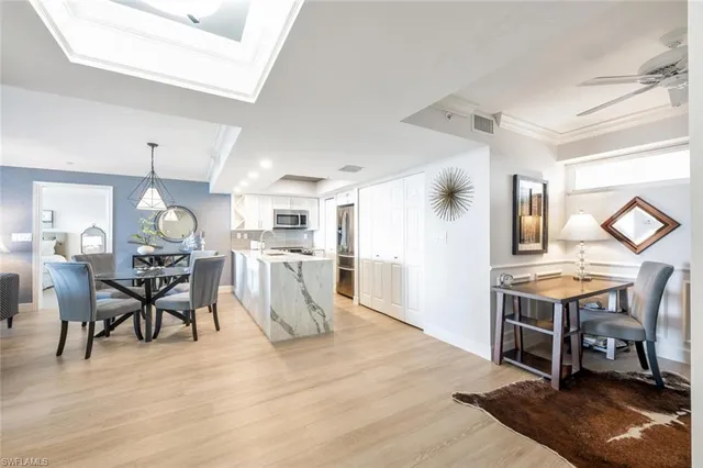 a dining room filled with furniture and wooden floor