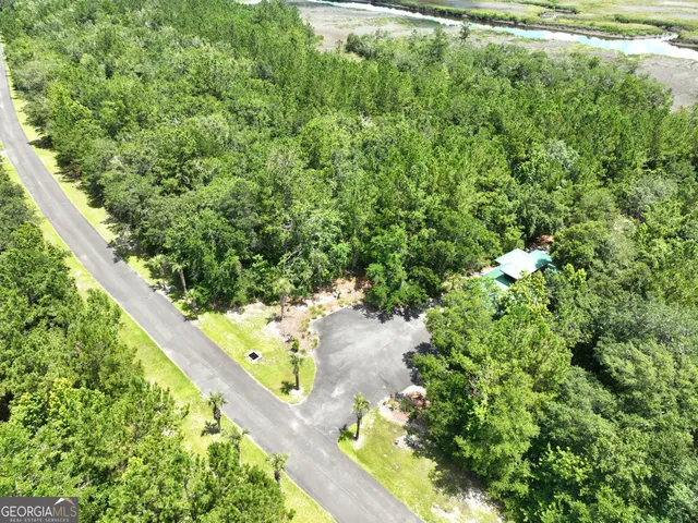 a view of a big yard with lots of green space and mountain view