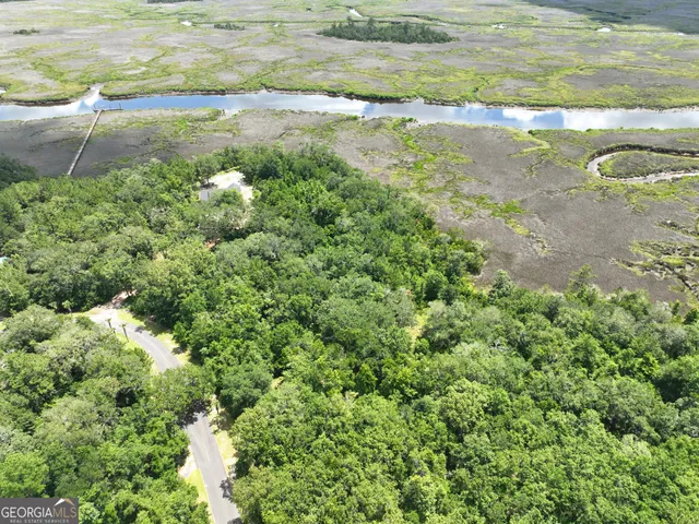 a view of a street with a barn in the background