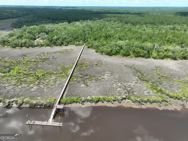 a view of a yard with large trees