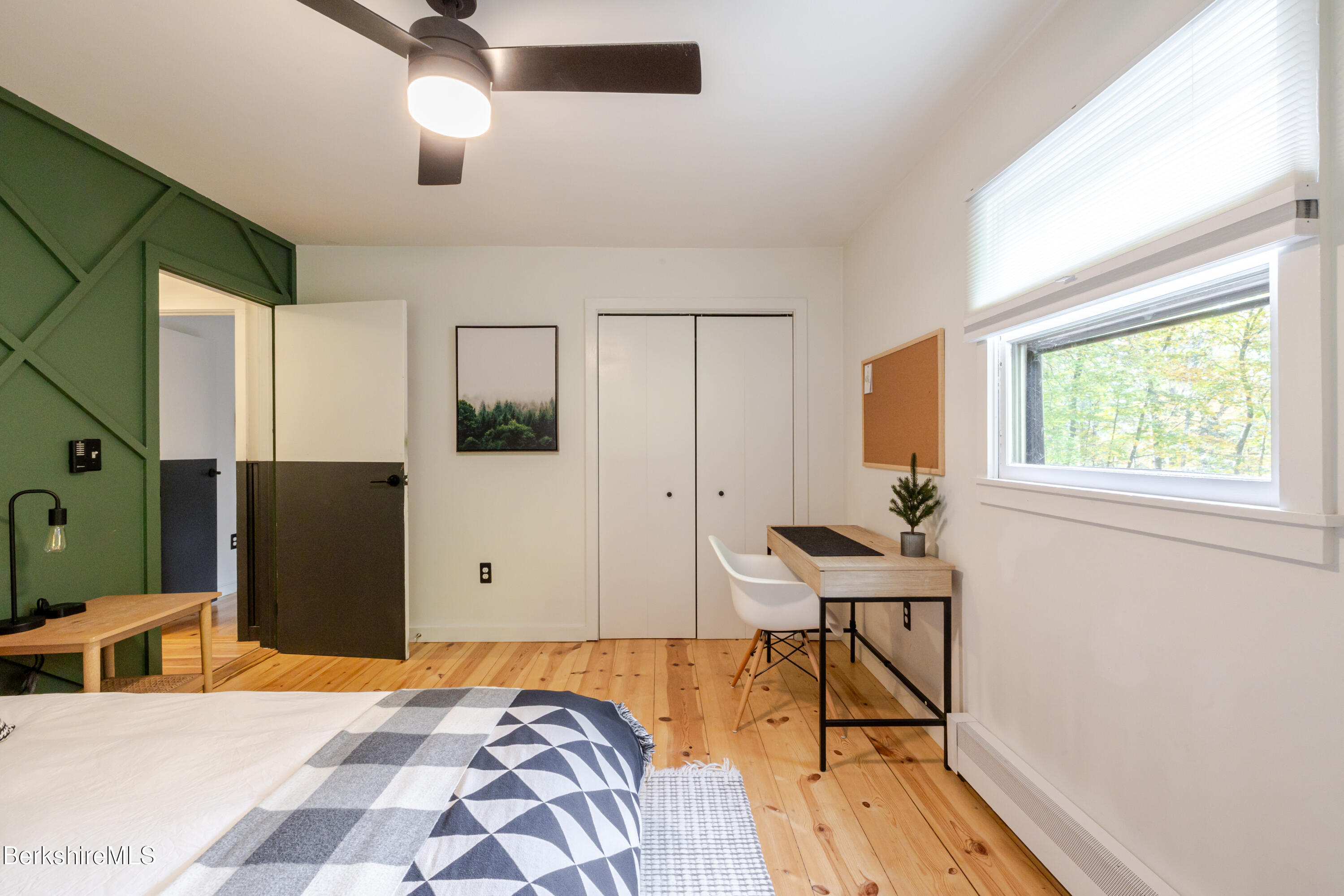 176 Division Street Great Barrington, MA 01230 - Photo 18 of 40 a bedroom with a bed and wooden floor