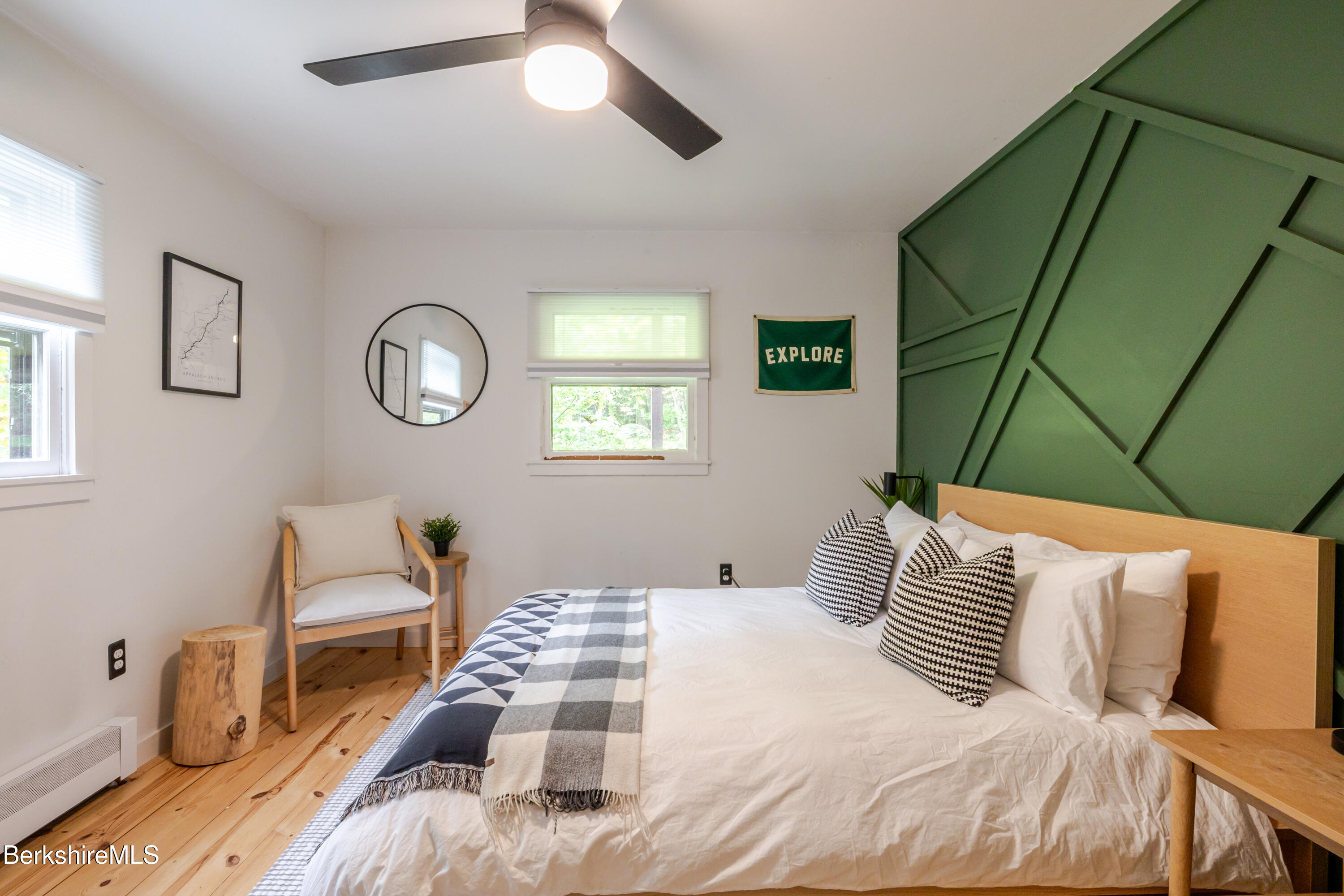 176 Division Street Great Barrington, MA 01230 - Photo 19 of 40 a bedroom with a bed and a chair