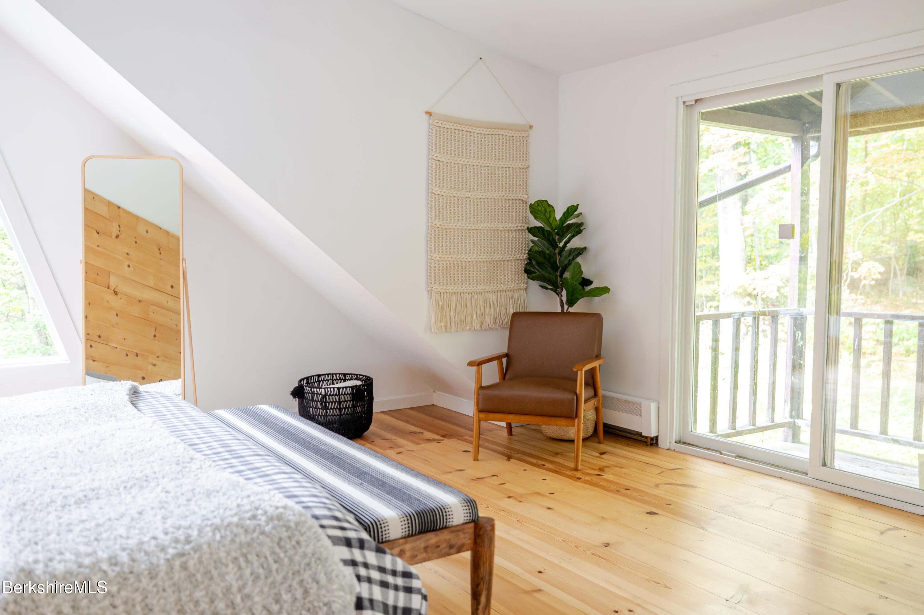 176 Division Street Great Barrington, MA 01230 - Photo 26 of 40 a bedroom with a bed and wooden floor