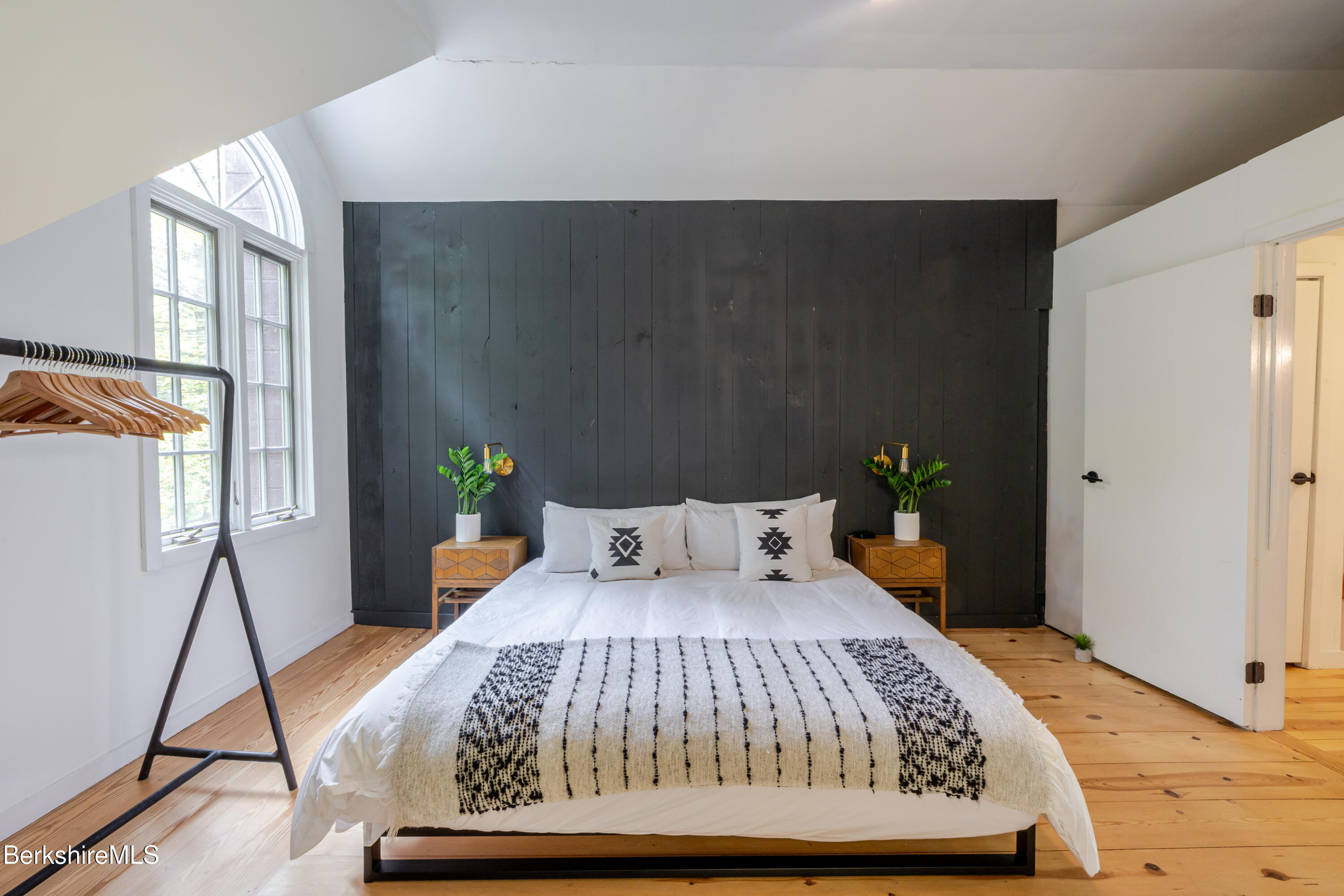 176 Division Street Great Barrington, MA 01230 - Photo 31 of 40 a bedroom with a bed and wooden floor