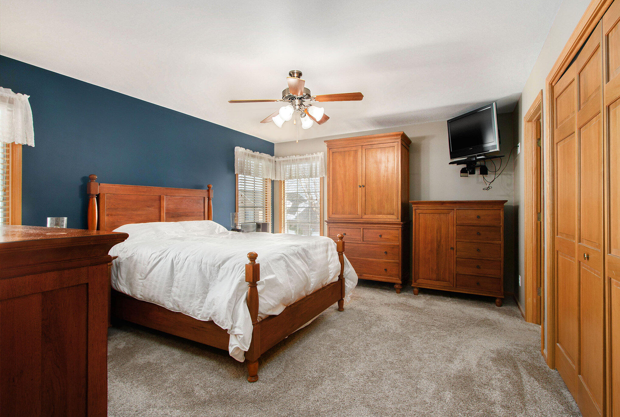 10399 Pike Street Crown Point, IN 46307 - Photo 12 of 25 a spacious bedroom with a bed and a chandelier