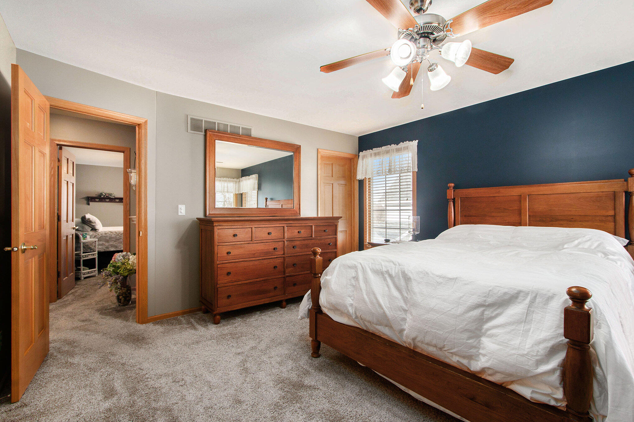 10399 Pike Street Crown Point, IN 46307 - Photo 13 of 25 a bedroom with a bed and a chandelier