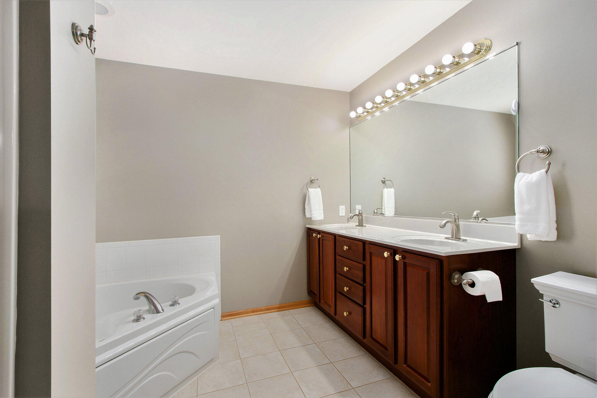 10399 Pike Street Crown Point, IN 46307 - Photo 14 of 25 a spacious bathroom with a double vanity sink and mirror