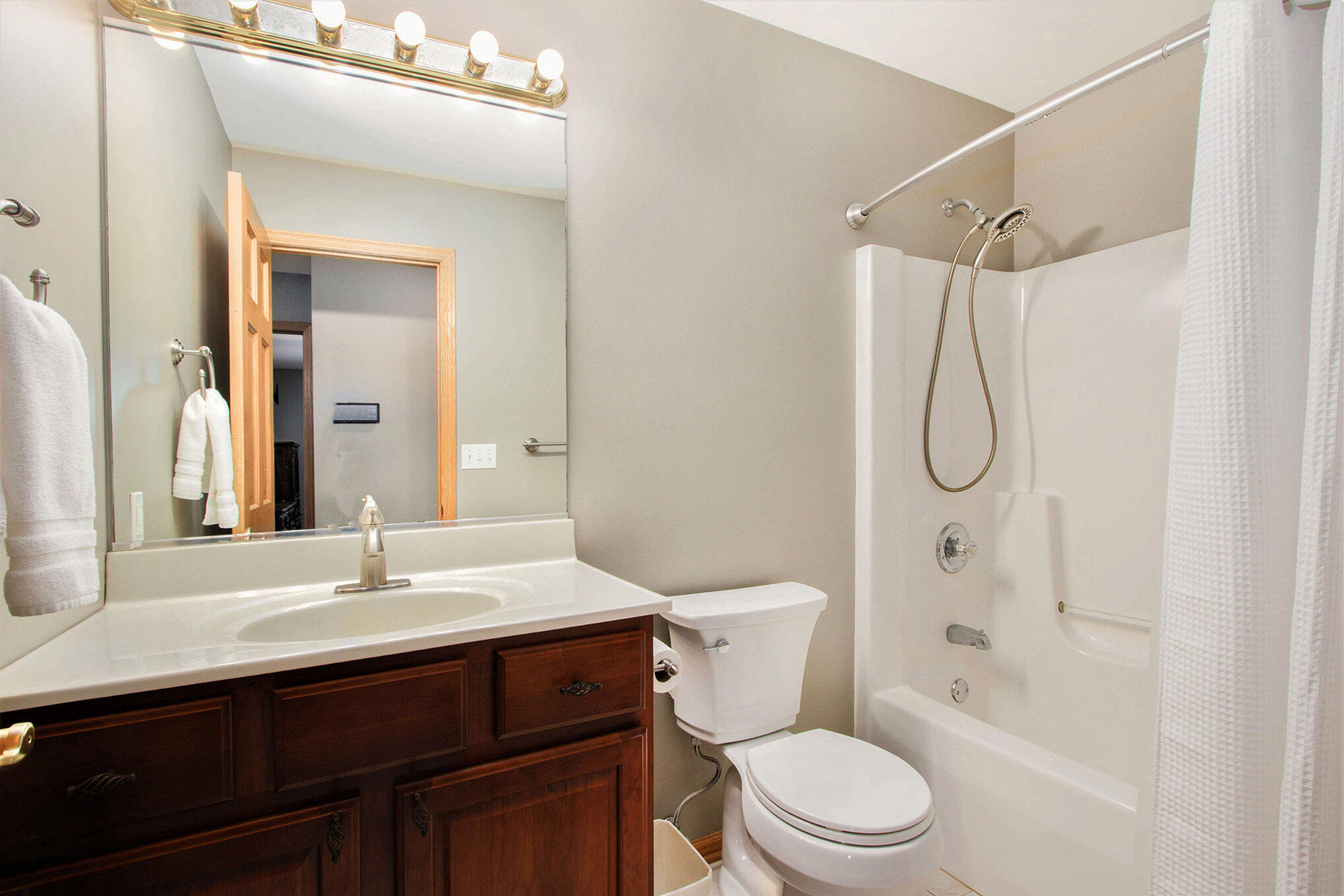 10399 Pike Street Crown Point, IN 46307 - Photo 17 of 25 a bathroom with a sink a toilet and a mirror