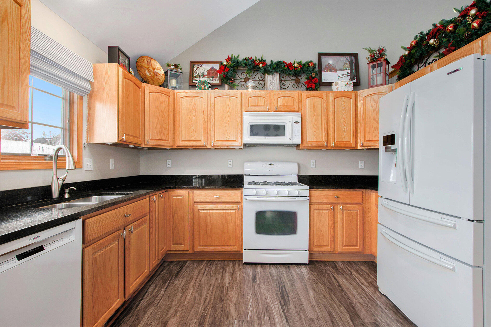 10399 Pike Street Crown Point, IN 46307 - Photo 7 of 25 a kitchen with stainless steel appliances granite countertop a sink a stove a refrigerator and island with wooden floor