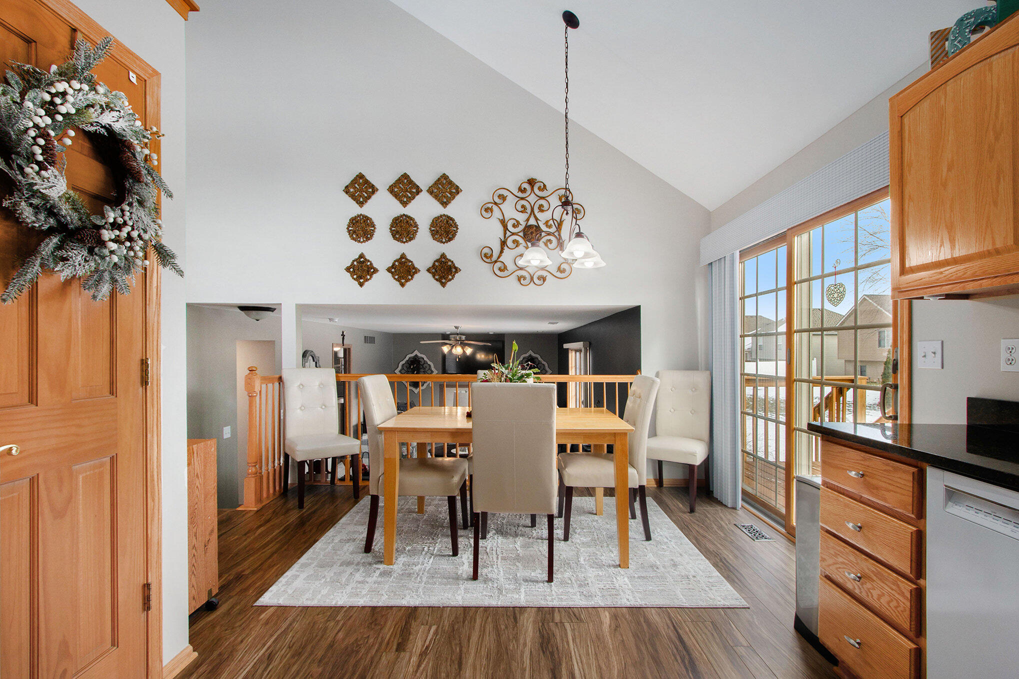 10399 Pike Street Crown Point, IN 46307 - Photo 9 of 25 a view of a dining room with furniture a chandelier and wooden floor