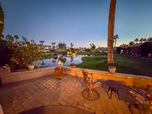a view of a swimming pool with a patio and a yard