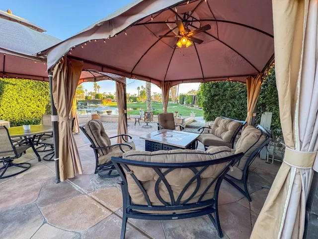 a patio with a patio table and chairs