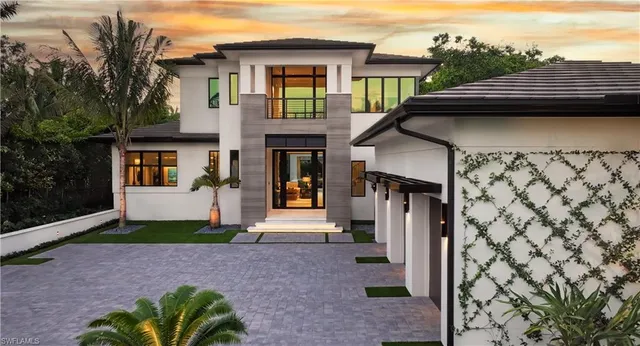 a front view of a house with a garden