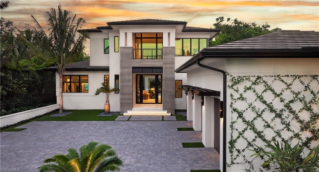 477 3rd Street North Naples, FL 34102 - Photo 1 of 33 a front view of a house with a garden