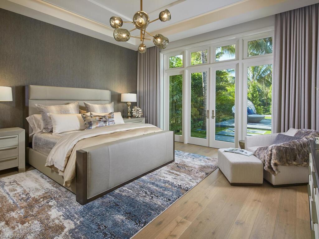 477 3rd Street North Naples, FL 34102 - Photo 13 of 33 a spacious bedroom with a bed and a large window