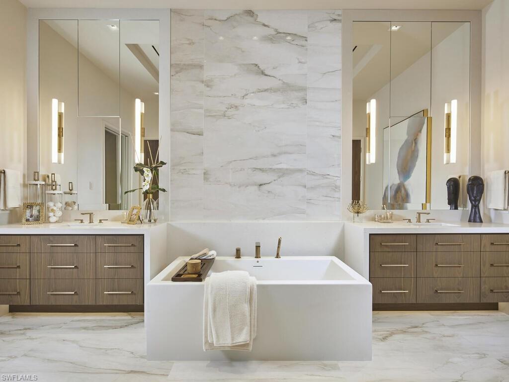 477 3rd Street North Naples, FL 34102 - Photo 16 of 33 a spacious bathroom with a tub sink and mirror